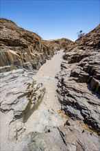 Dry river valley with basalt rocks, rock formation Organ Pipes, Damaraland, Kunene, Namibia, Africa