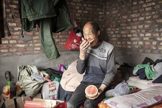 Worker Yang Zhao Bin at his sleeping place, the workers live in the respective buildings where the