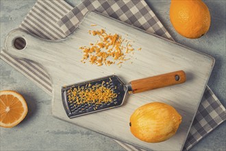 Grated lemon zest, on a cutting board, with a grater, top view, no people