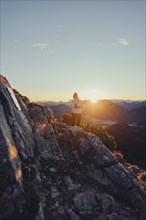 Trail running in autumn on the Jochberg on Lake Walchensee against the wonderful backdrop of the