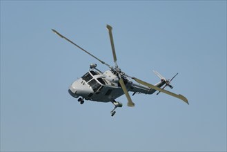 Military helicopter in blue sky