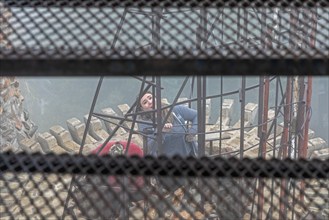 Rye, Colorado, Visitors explore a tower on Bishop Castle on a foggy morning. The Castle is an