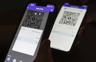 In this photo illustration, the PhonePe QR code, is seen displayed on mobile phones screen in