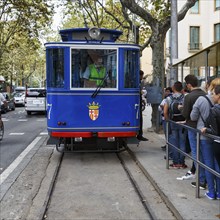 Nostalgic blue tram, tourist group waiting at the stop, Tramvia Blau, Art Nouveau, Barcelona,