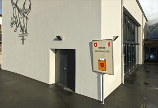 Sign inviting people to participate in referendums in front of the polling station, Unterbäch,