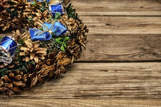 Christmas wreath on old wooden background close up