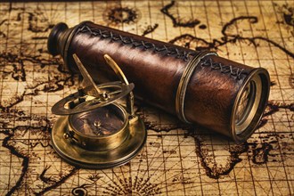 Travel geography navigation concept background, old vintage retro compass with sundial and spyglass