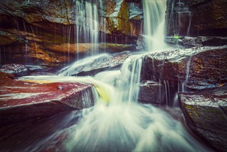 Vintage retro effect filtered hipster style image of tropical waterfall. Popokvil Waterfall, Bokor