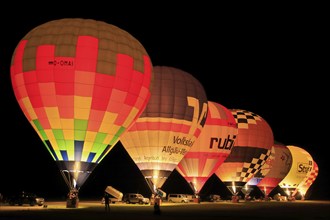 Illuminated hot air balloons at balloon festival at night, Landshut, Bavaria, Germany, Europe