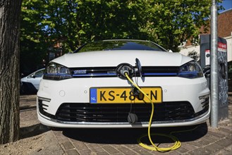 AMSTERDAM, NETHERLANDS, MAY 8, 2017: Volkswagen Golf GTE petrol-electric hybrid car being charged