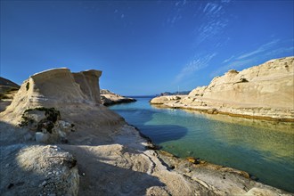 White rocks of famous tourist attraction of Milos island Sarakiniko beach with tourist relax and