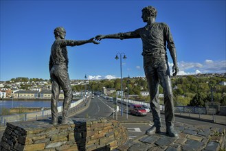 Bronze sculpture Hands Across the Divide by Maurice Harron at the Craigavon Bridge over the River