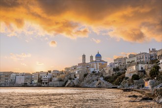 View of the village with the Greek Orthodox church of Agios Nikolaos, Asteria Beach, at sunset with