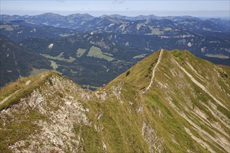 Ridge trail between Fellhorn and Söllerkopf peaks, behind Allgäu Alps and Illertal valley,