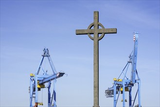 Visserskruis, Fishermen's Cross and container terminal cranes in the seaport of Zeebrugge, West