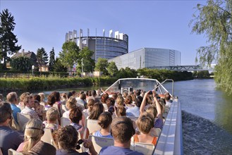 Excursion boat with tourists in front of the buildings of the European Parliament, Strasbourg,