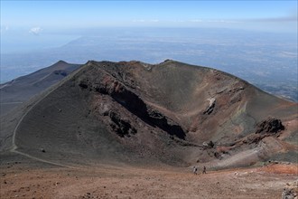 Hikers in the crater landscape of the volcano Etna, summit region, province of Catania, Sicily,