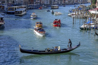 Venetian gondola at the Rialto Bridge on the Grand Canal, San Marco district, Venice, Veneto