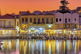 Venetian harbour, dusk, night shots, orange sky, colourful rows of houses, water reflection,