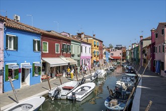 Colourful houses on the canal with reflection, Canal with boats and colourful house facades, Burano