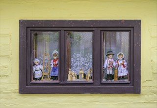 Window with traditional traditional costume dolls, Vlkolinec village, Unesco World Heritage Site,