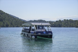 Electric ferry with solar roof sails to Benedictine Abbey, Mljet Island, Dubrovnik-Neretva County,