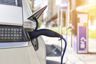 Charging the battery of an electric car with electricity E-car at an electric petrol station petrol