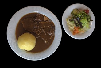 Sauerbraten with dumpling and salad, black ground, Bavaria, Germany, Europe