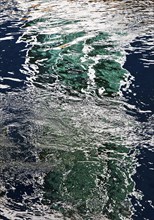 Moving reflection of a ship detail on the water surface of the Rhine, Bonn, Rhineland, North