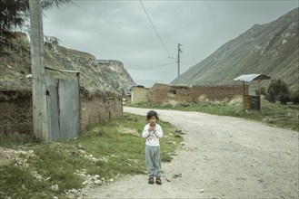 Child on the street in a hamlet, Curipata, Peru, South America