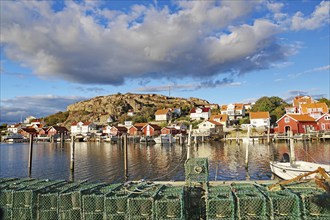 Lobster cages, harbour and small wooden houses in the autumn evening light, Fjällbacka, Bohuslän,