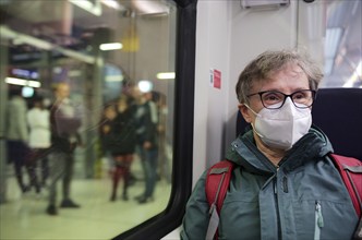 Elderly woman with mouth mask, sitting in S-Bahn, Corona crisis, Stuttgart, Baden-Württemberg,