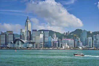 HONG KONG, CHINA, MAY 1, 2018: Boat in Victoria Harbour and Hong Kong skyline cityscape downtown