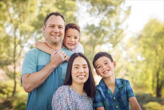 Outdoor portrait of biracial chinese and caucasian family