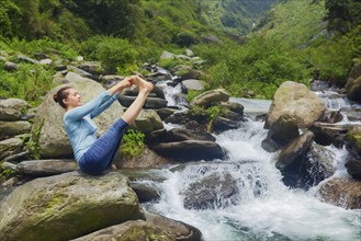 Yoga exercise outdoors, panorama of woman doing Ashtanga Vinyasa Yoga balance asana Ubhaya