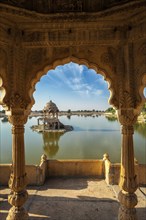 Indian landmark Gadi Sagar, artificial lake view through arch. Jaisalmer, Rajasthan, India, Asia