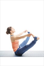 Beautiful sporty fit woman doing Ashtanga Vinyasa yoga asana Upavistha konasana B, wide sitted