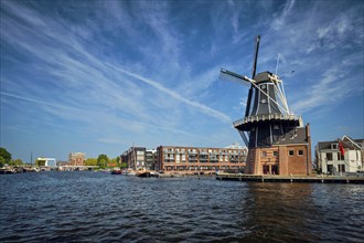 View of Harlem landmark windmill De Adriaan on Spaarne river. Harlem, Netherlands