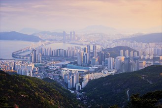 Busan cityscape with skyscrapers and Gwangan Bridge on sunset from Jangsan peak. Busan, South