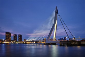 Erasmus Bridge (Erasmusbrug) and Rotterdam skyline illuminated at night. Rotterdam, Netherlands