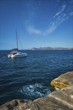 Yacht boat in Aegean sea at white rocks of Sarakiniko Beach, Milos island, Greece, Europe