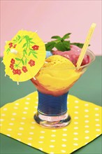 Sundae with homemade ice cream, yellow umbrella, ice cream cone and mint leaves, summer, Germany,