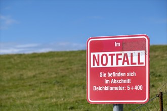 Emergency sign on a dike, North Sea island of Föhr, Schleswig-Holtstein, Germany, Europe