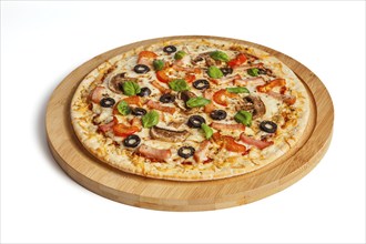 Ham pizza with (capsicum), mushrooms, olives and basil leaves isolated on white