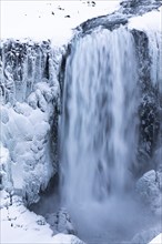 Dettifoss waterfall with icy and snow-covered rock face, Northern Iceland Eyestra, Iceland, Europe