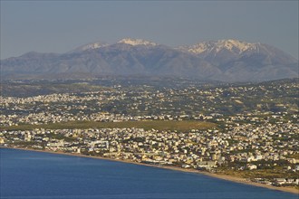 Panorama shot, overview, Dikte massif, snow-capped mountains, sea of houses, blue sea, coast,