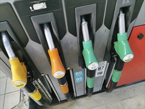 Petrol pump with nozzles for petrol and diesel at a motorway filling station in France