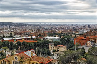 View of the sea of houses up to the coast, cloudy sky in autumn, haze, Tibidabo, Barcelona, Spain,