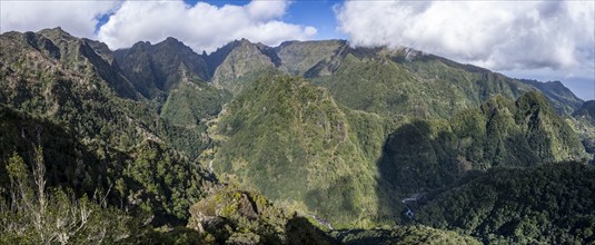 Densely overgrown steep mountains, green mountain landscape, view from the Miradouro dos Balcões,