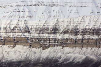 Snow covered Carboniferous mountain slope showing strata in autumn, Billefjord, Billefjorden,